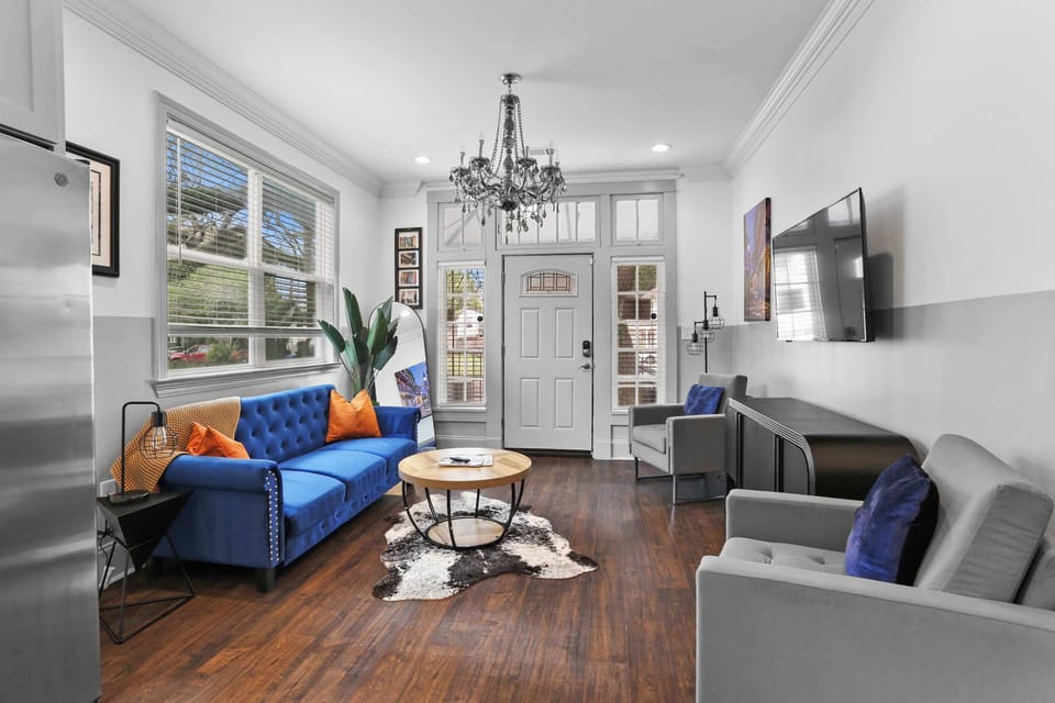 Relax in the bright living room with comfortable seating, a Smart TV, hardwood floors, and an open layout perfect for spending time together.