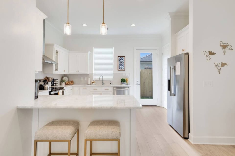 The kitchen has a bar area for extra dining space