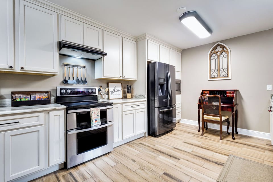 Bright modern kitchen with stainless appliances and charming desk nook