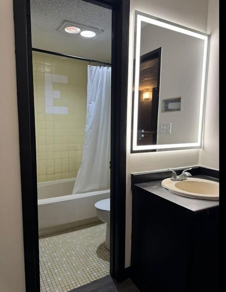 Separate tub and shower, towels, soap, toilet paper
