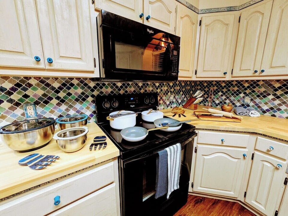 Relish in the custom everything in this delightful, fully loaded, kitchen! From the butcher block counter tops to cabinet trim and HUGE farmhouse sink, every apsect of this kitchen has been crafted for your cooking and gathering experience.