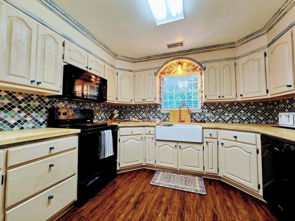 Relish in the custom everything in this delightful, fully loaded, kitchen! From the butcher block counter tops to cabinet trim and HUGE farmhouse sink, every apsect of this kitchen has been crafted for your cooking and gathering experience.