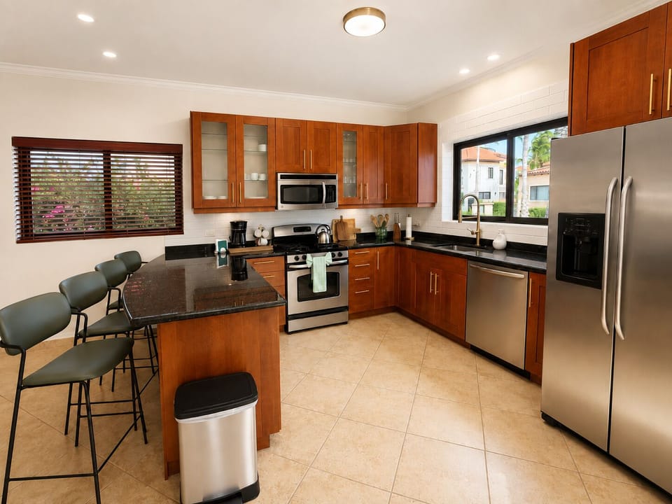 The open-concept kitchen features a convenient breakfast bar island, perfect for quick bites or socializing while cooking.