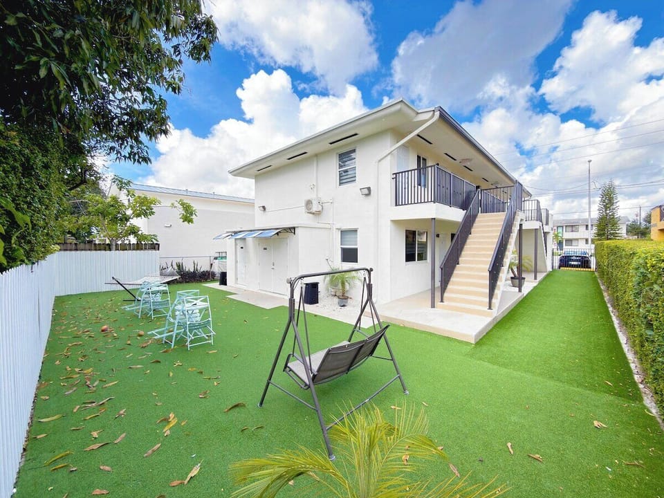 Shared outdoor area with seating, a hammock, and a swing.
