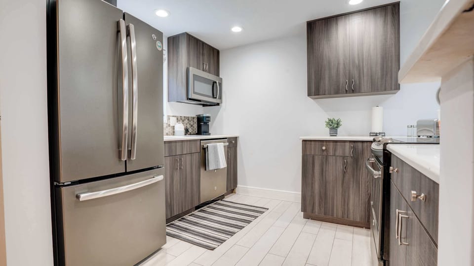 Fully equipped kitchen with modern appliances, cookware, and essentials.