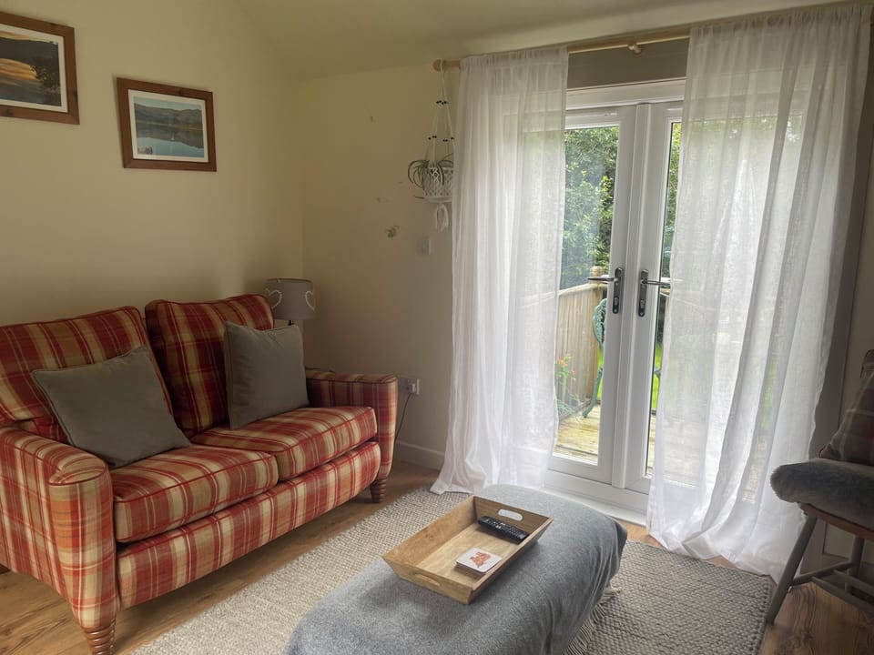 The cosy living room has a wood burning stove.