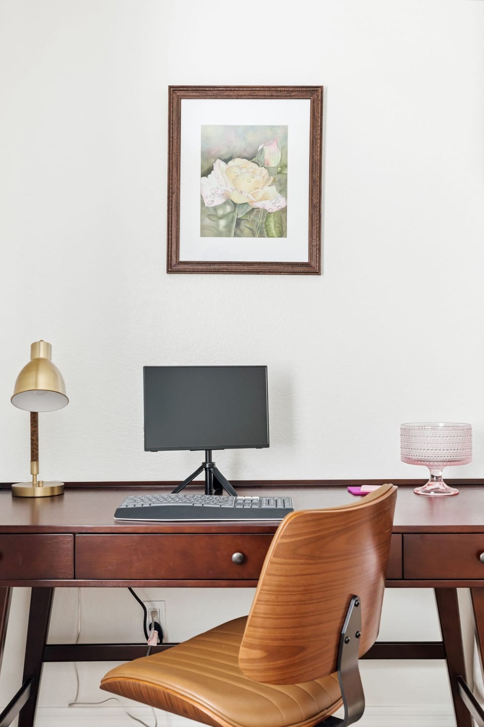 Dedicated workspace with stylish desk setup and warm, modern decor