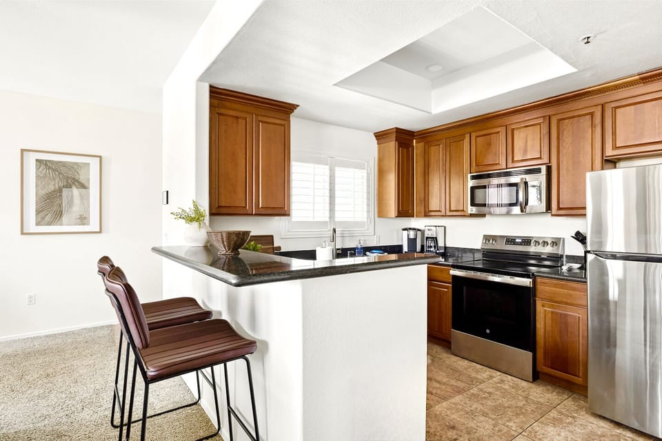 Bright open kitchen with breakfast bar and stainless steel appliances