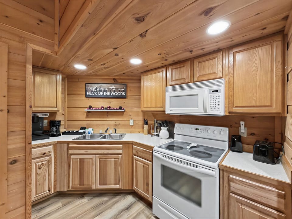 Cozy wood cabin kitchen with full appliances and rustic charm