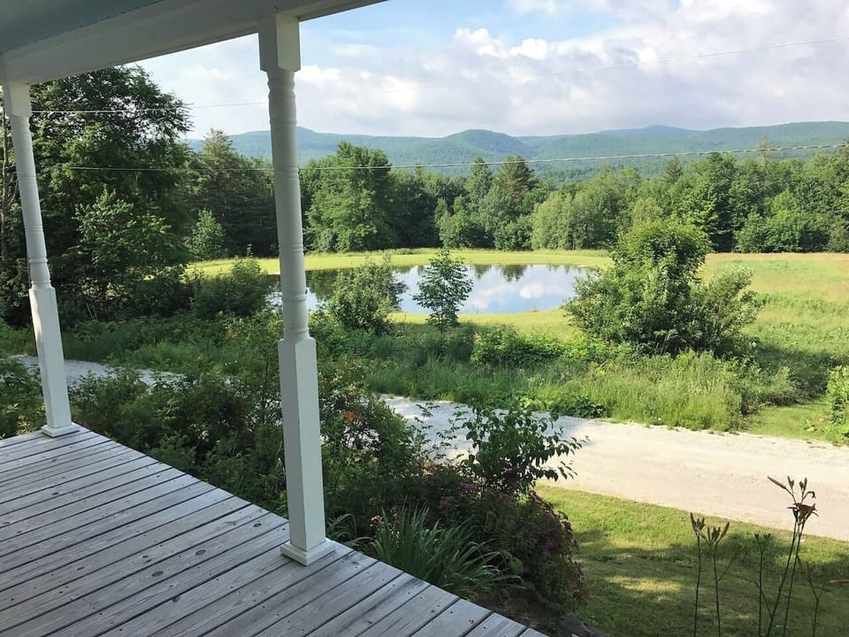 View from porch to pond and Green Mountains