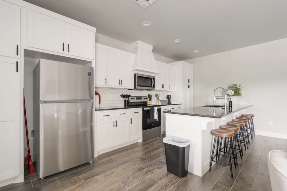 Bright modern kitchen with large island seating and stainless appliances