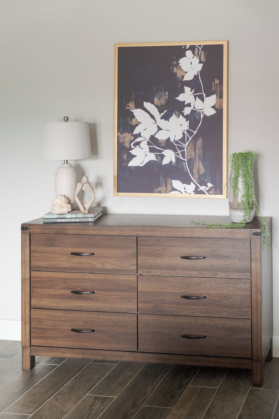 Stylish wood dresser with modern artwork and elegant decor accents