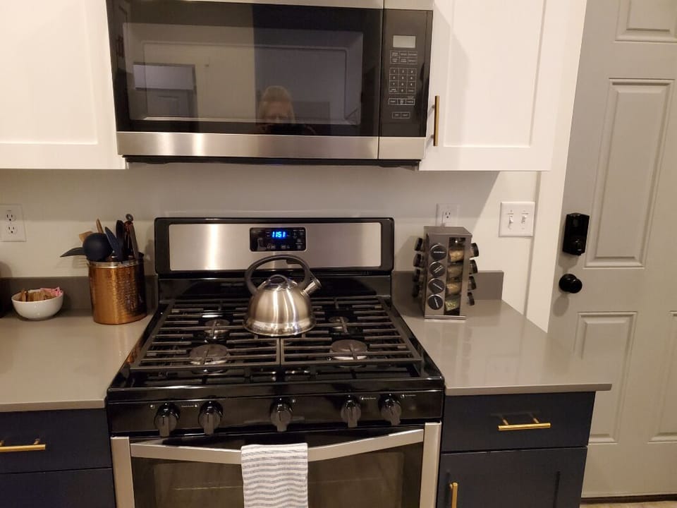 Gas range, oven, microwave, spices, cooking utensils.