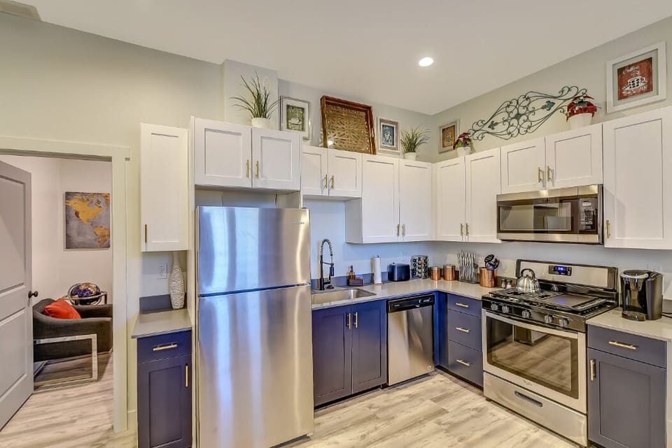 Fully equipped kitchen w/ fridge, sink, dishwasher, gas range, oven, microwave. 