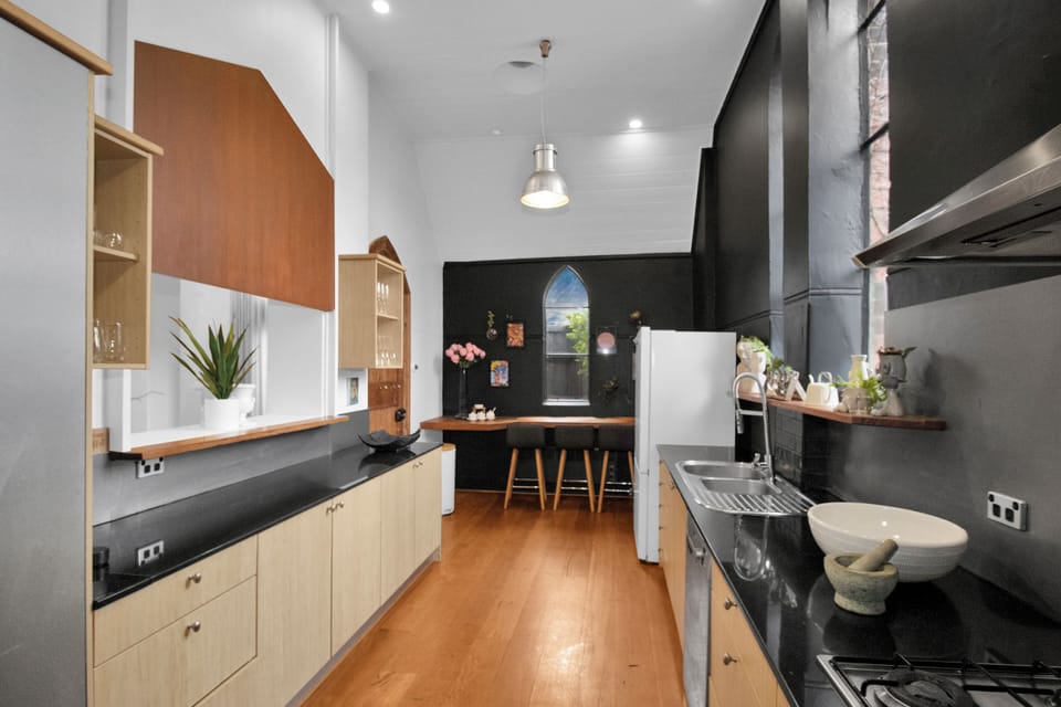 Stylish galley kitchen with breakfast nook and striking modern finishes