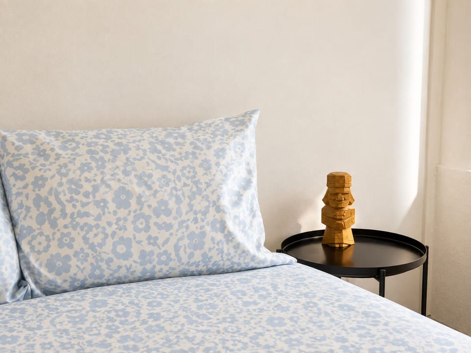 Bright, cozy bedroom with soft floral bedding and stylish accents