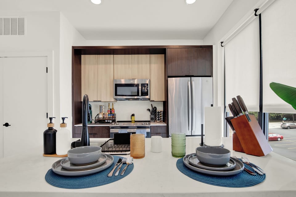 Bright modern kitchen with island seating and stainless steel appliances