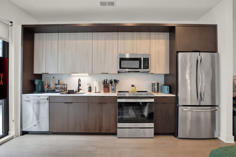 Modern full kitchen with stainless steel appliances and stylish finishes