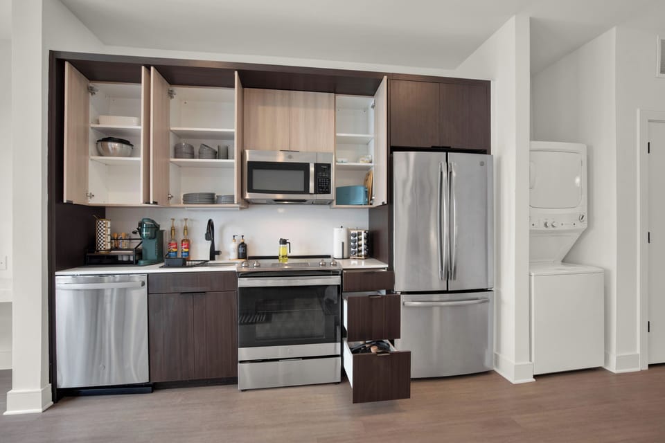 Modern kitchen with stainless appliances and in-unit washer/dryer