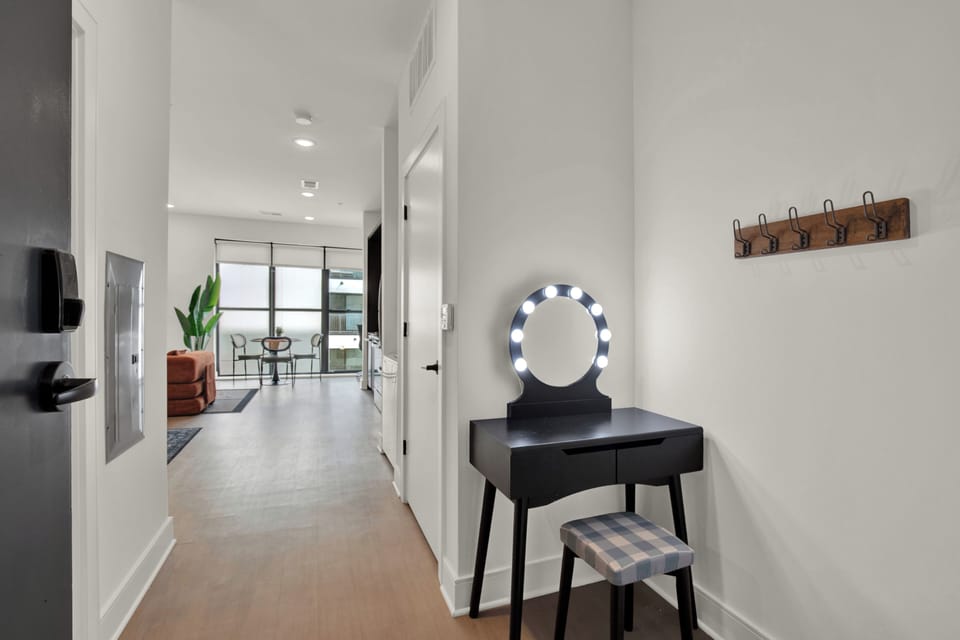 Bright modern entryway with vanity, natural light, and open living space