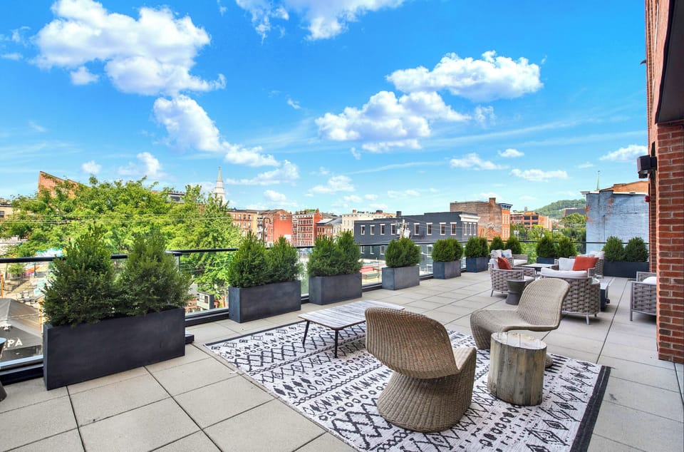 Spacious rooftop terrace with chic lounge seating and sweeping city views