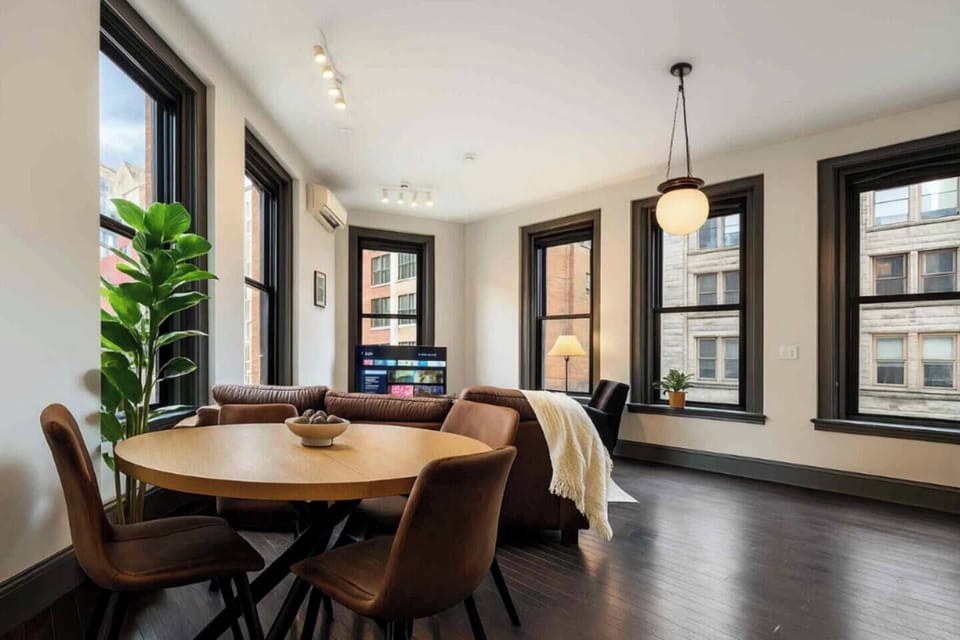 Bright open living space with city views, stylish dining, and modern comfort