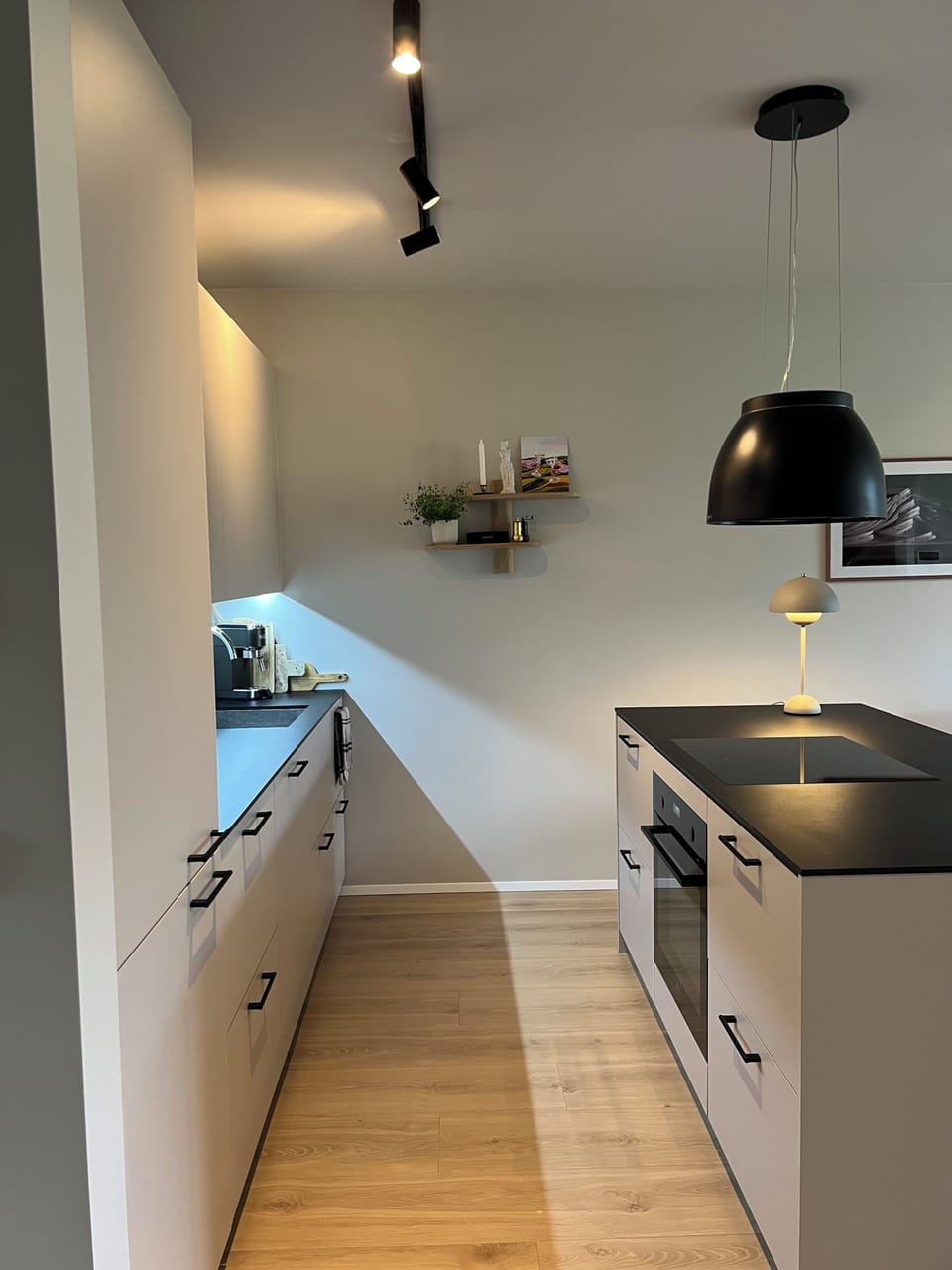 Kitchen with an island, stovetop and oven. 