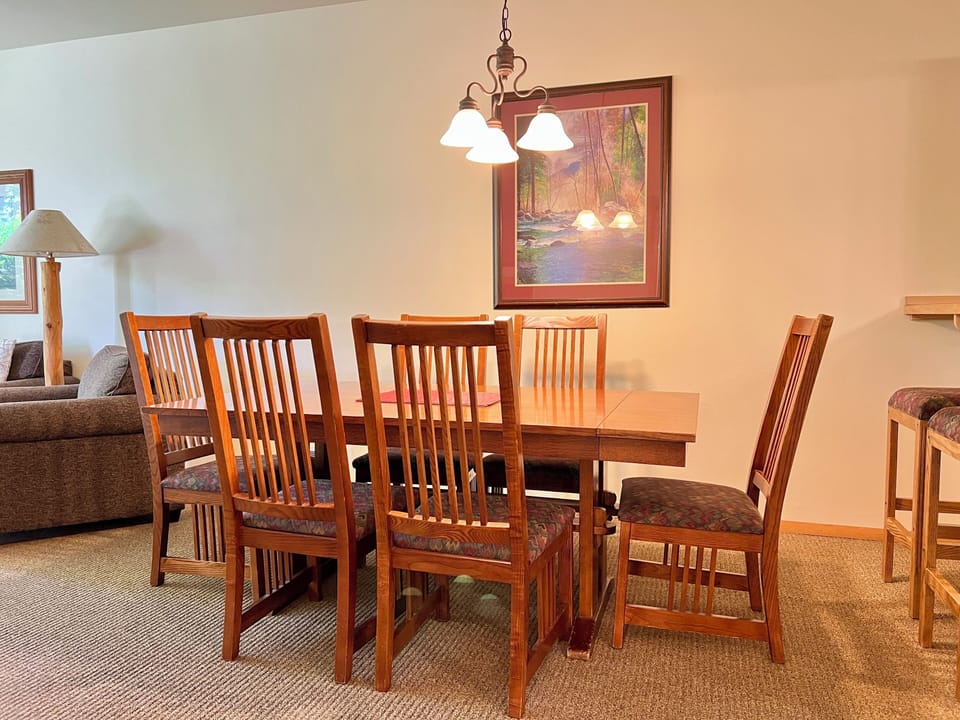 Warm wood dining area with seating for six and cozy open-concept layout