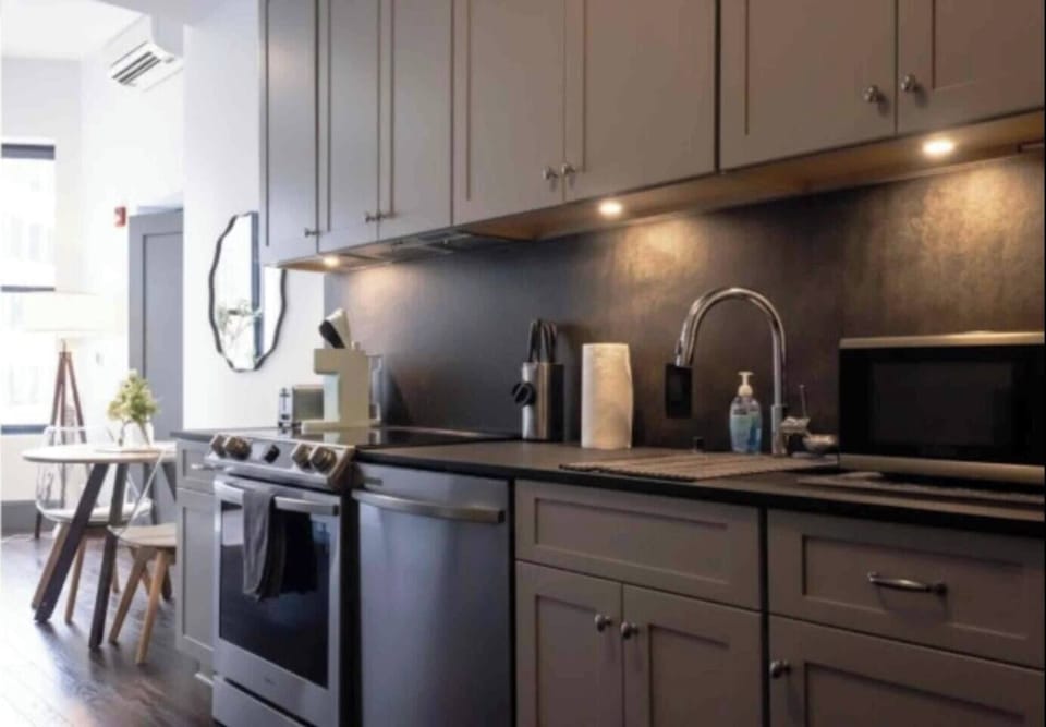 Modern, fully equipped kitchen with cozy dining nook and warm lighting