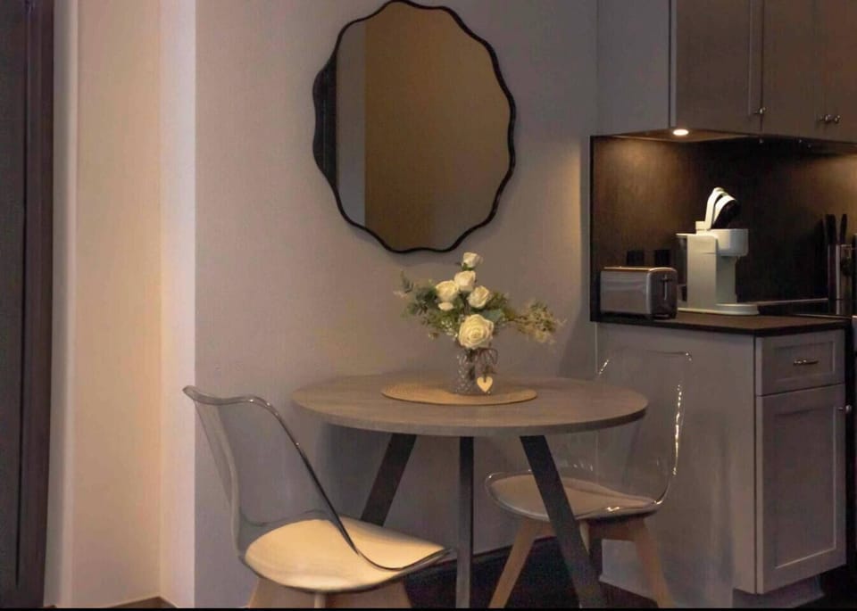 Cozy dining nook with sleek kitchenette and coffee station