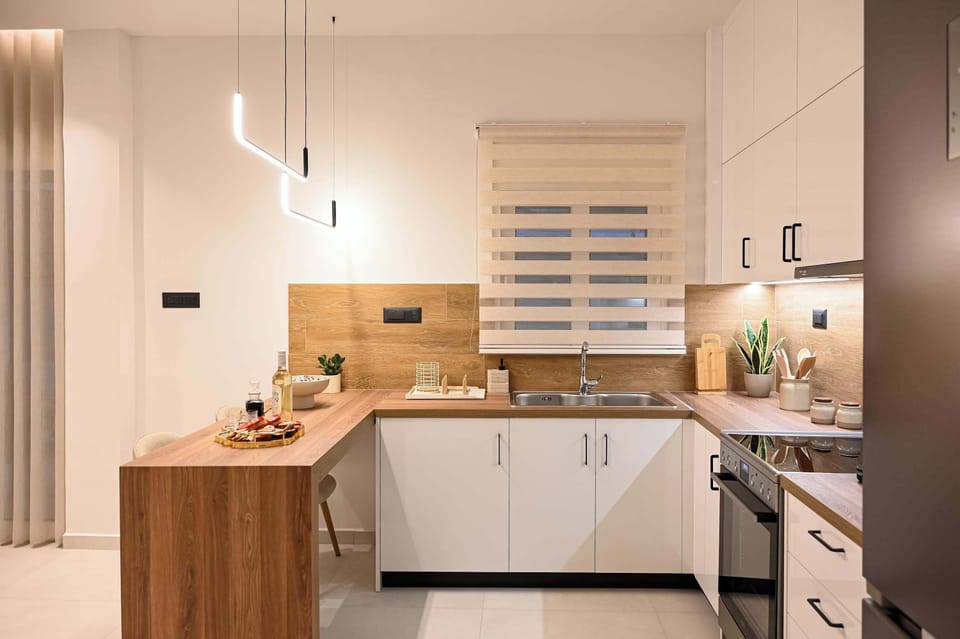 A bright and practical kitchen with generous counter space, connected naturally with the apartment’s dining and living areas.