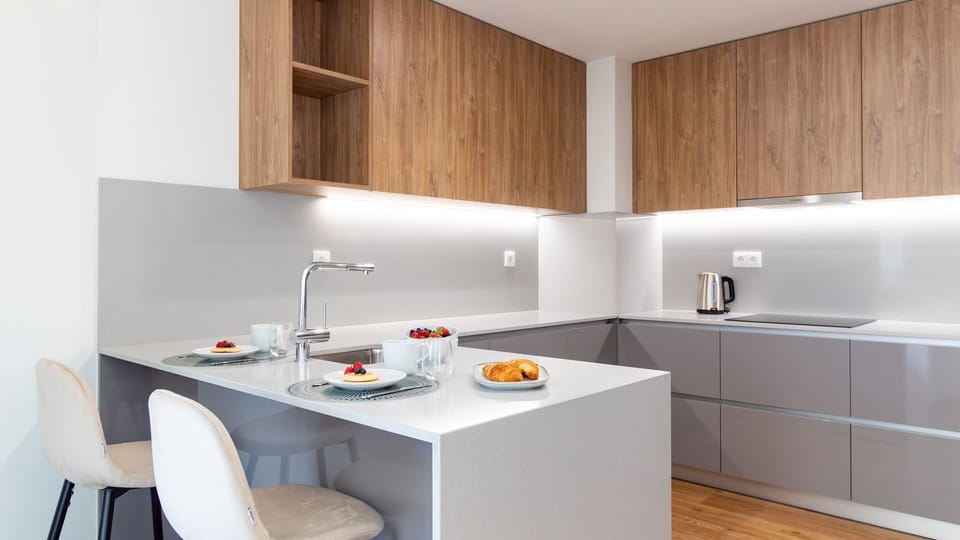 Enjoy a delightful start to your day with breakfast served at this sleek kitchen island, featuring modern design and ample space for casual dining. The integrated sink and contemporary finishes make meal prep a breeze.