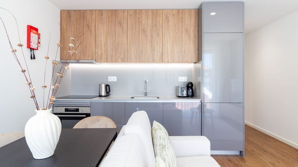 Prepare your favorite meals with ease in this sleek, fully equipped kitchen, featuring modern appliances and ample counter space. Enjoy the convenience of a home-cooked breakfast or a late-night snack in your private retreat.