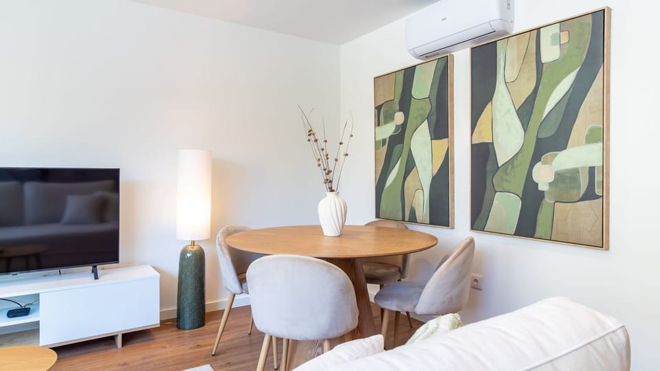Gather around the chic dining table for memorable meals or enjoy a cozy night in, watching your favorite shows on the large flat-screen TV. The thoughtful design creates a perfect ambiance for both dining and relaxation.