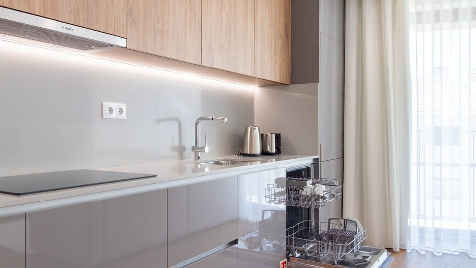 Prepare gourmet meals with ease in this fully equipped kitchen, featuring sleek countertops, modern appliances, and a convenient dishwasher to make cleanup a breeze. Wake up to natural light pouring in, promising a bright start to your day.