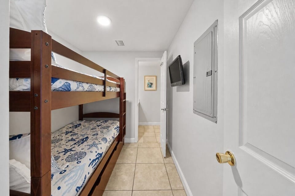 Bunk Nook with Twin Over Twin Size Bunk Bed and Flat Screen TV