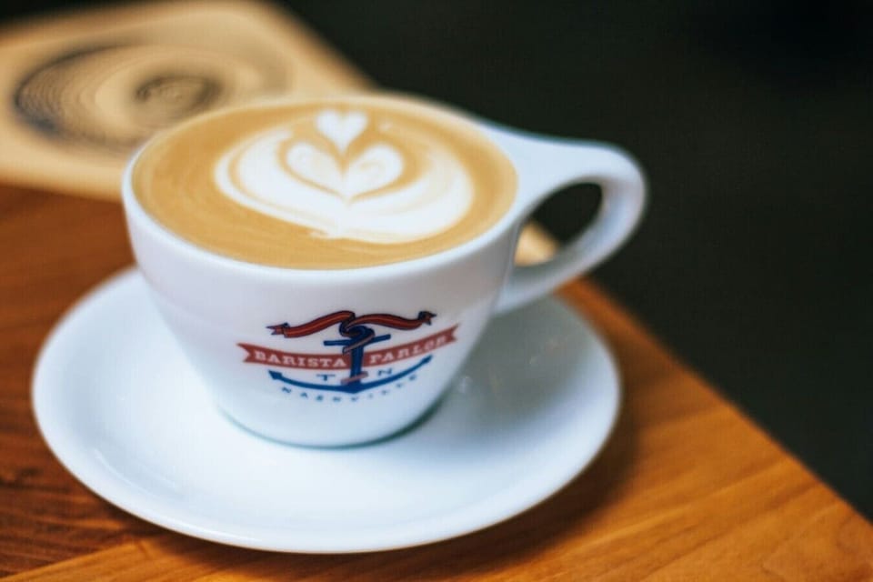 A perfectly poured latte from Barista Parlor in Nashville — where bold flavor meets artistic flair. Book your stay now!