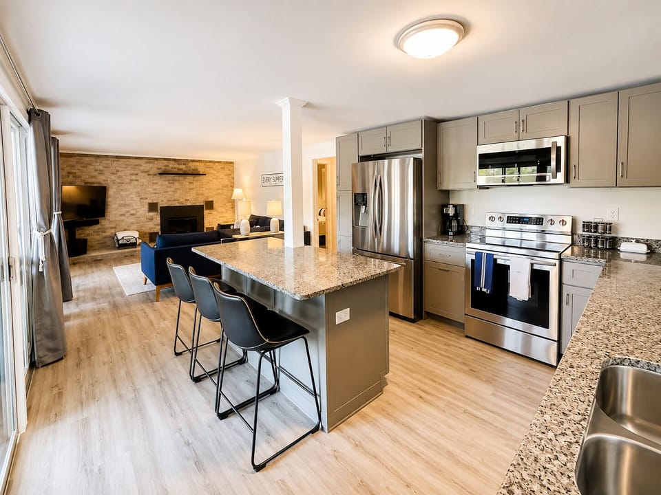 Open kitchen and living area inside this cozy Locke Lake home near Gunstock.