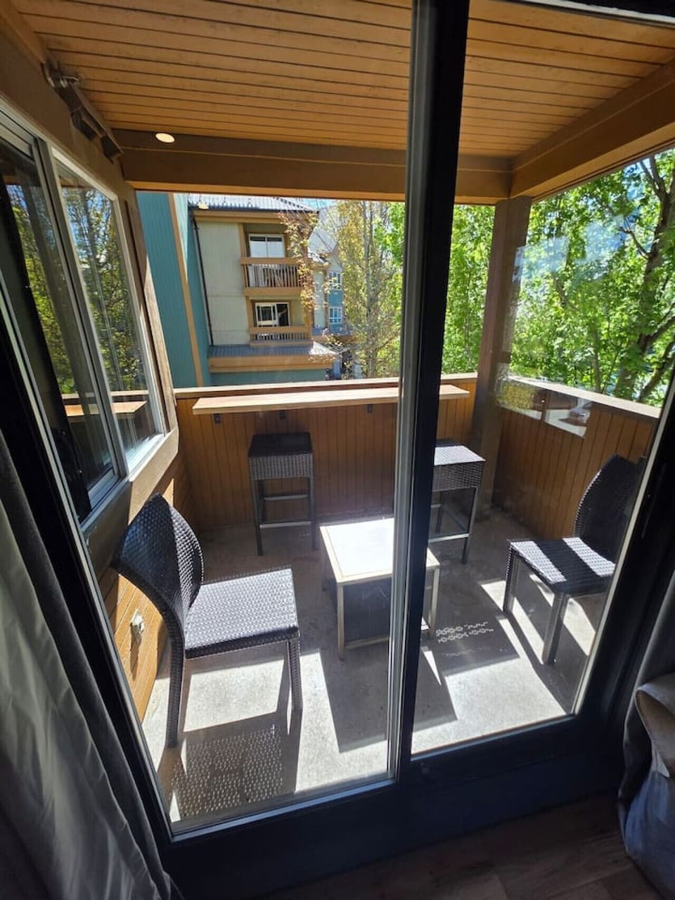 Covered balcony with seating and mountain views.