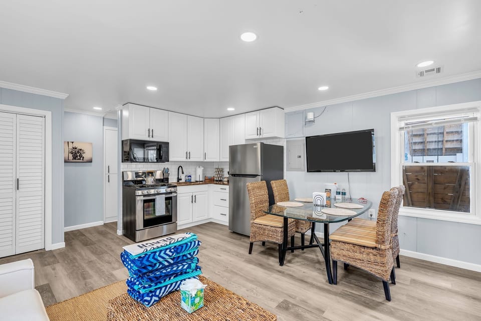 Bright modern kitchen with stainless appliances and cozy dining area