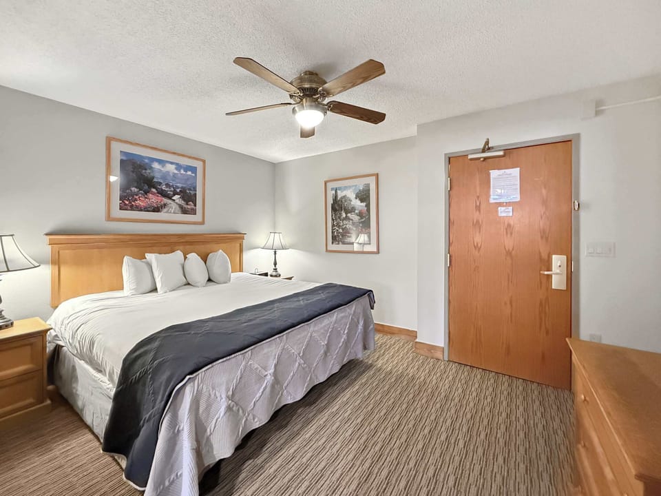 【King Bedroom 1】King bed, room-darkening shades, and floor space for the gear bags