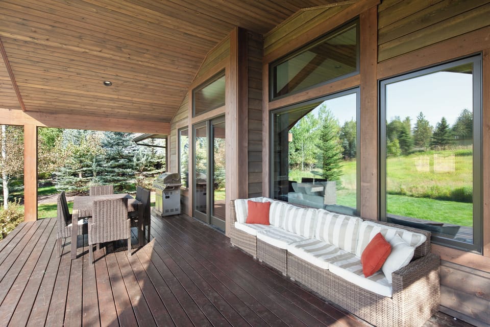 Sip coffee on the covered deck with peaceful forest air.