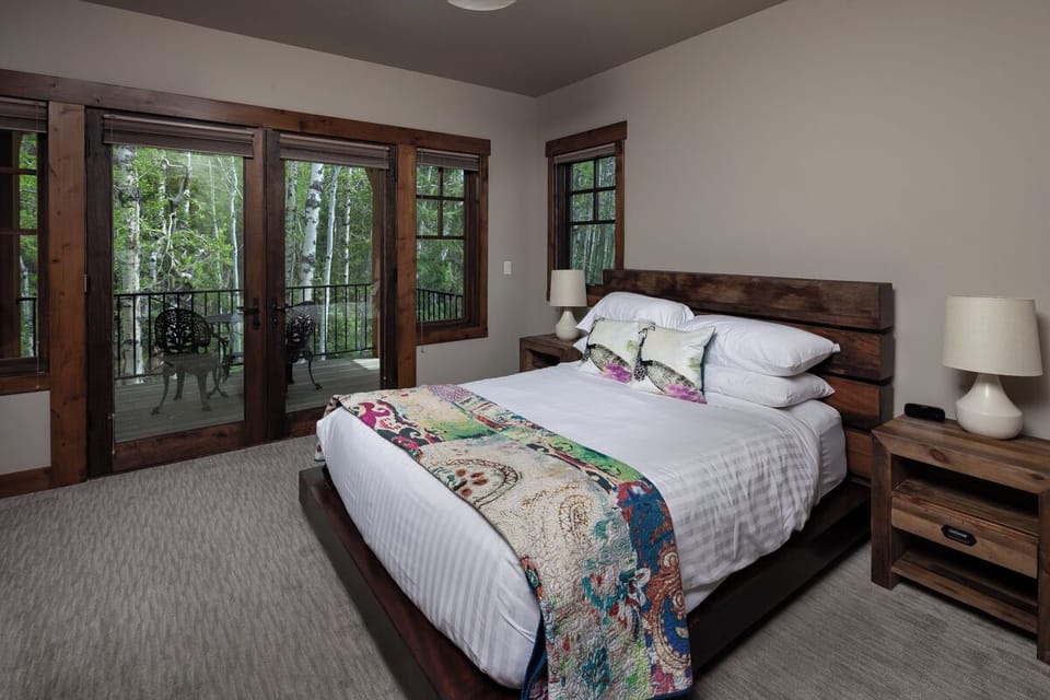 Wake up to forest views from your plush king retreat.