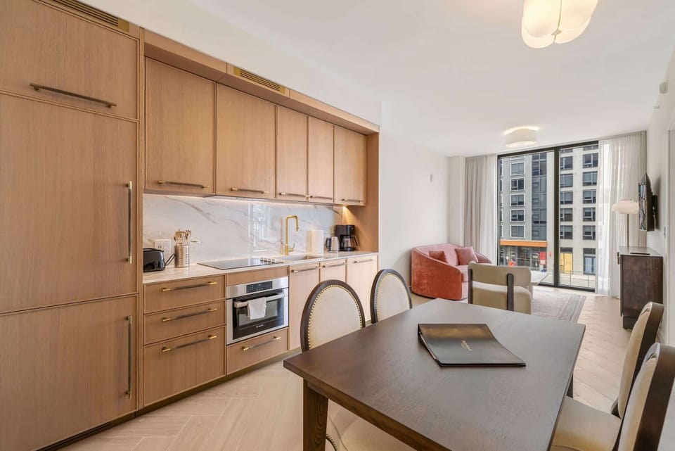 Stylish kitchen with modern amenities and a cozy living area, perfect for relaxing after a day in the city.