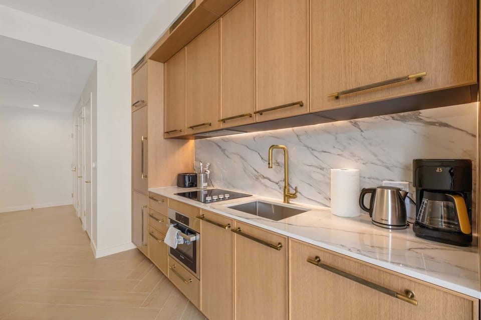Sleek and modern kitchen with high-end appliances and elegant finishes, perfect for culinary enthusiasts.