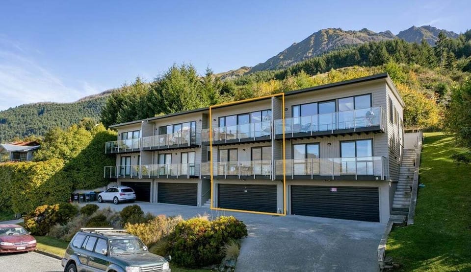 Exterior view of the property with garage and off-street parking.