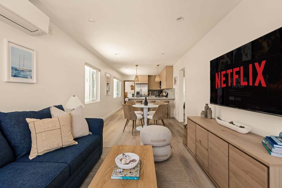 Open concept living room, dining area with breakfast bar and fully stocked kitchen.