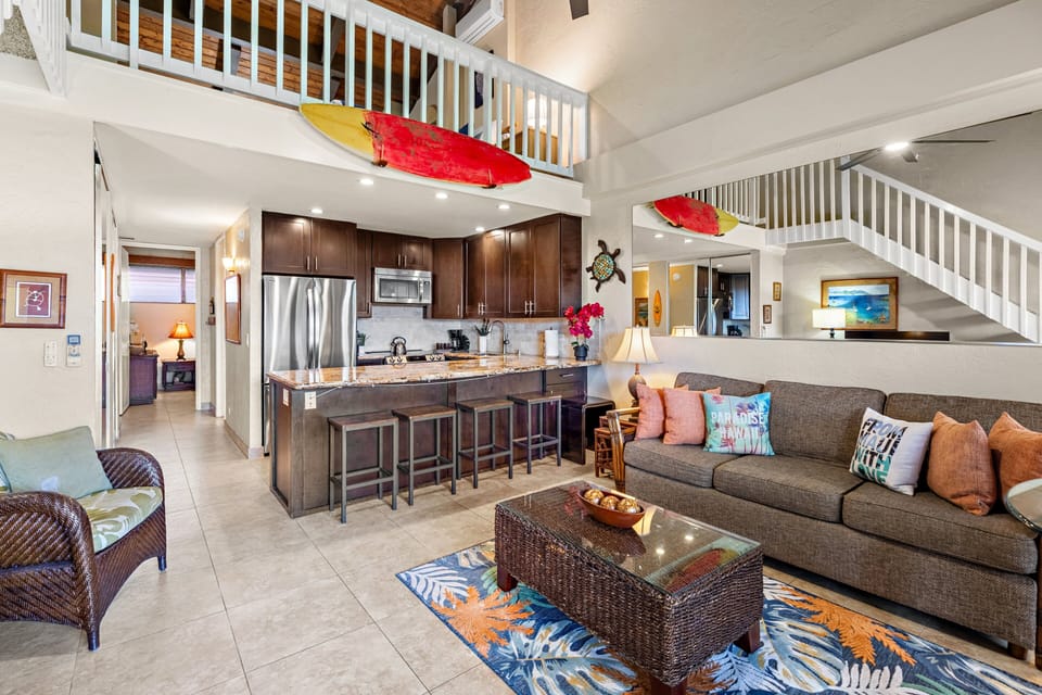 A spacious gathering area featuring comfortable seating, a large TV, and a welcoming island atmosphere.