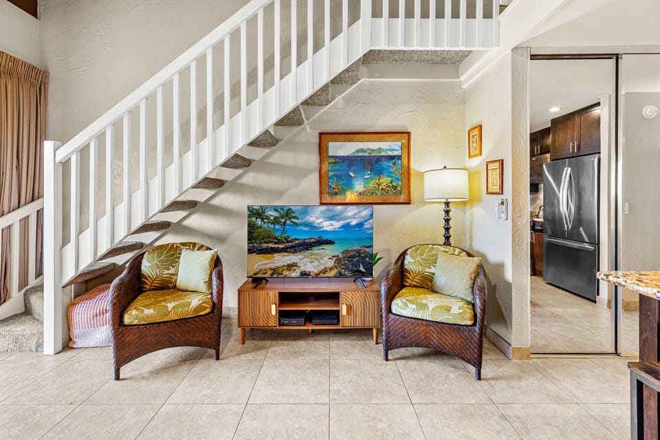 A cozy seating area offers a comfortable place to relax, read, or enjoy a movie.