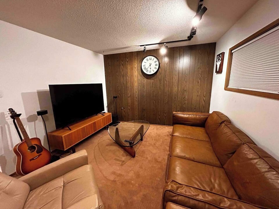 Cozy living room downstairs with 65 inch TV
